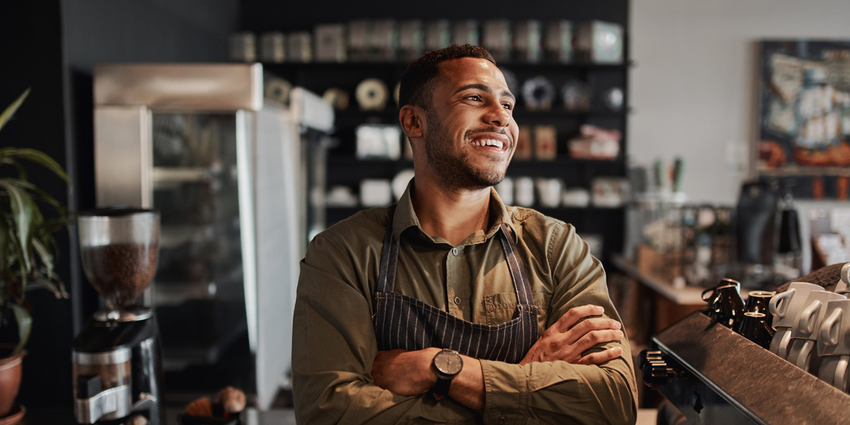 Small Businessman in Coffee Shop learning tips for financial success