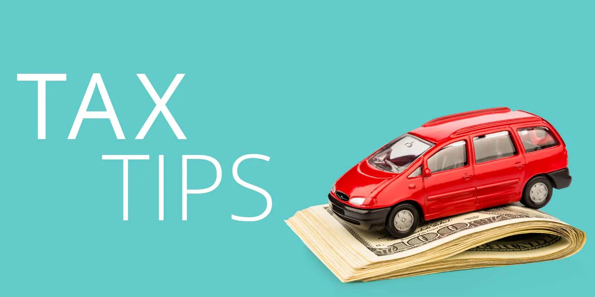 Red business van model on a pile of folded paper currency; on Russo blue background with the white words "Tax Tips."