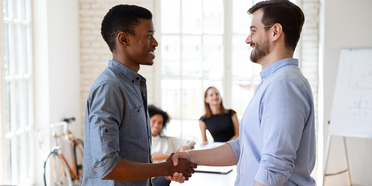 A manager shaking hands with an employee.