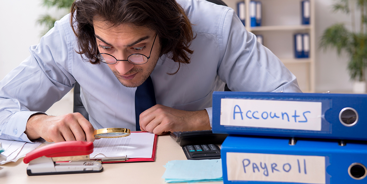 A man taking a closer look at finance documents.
